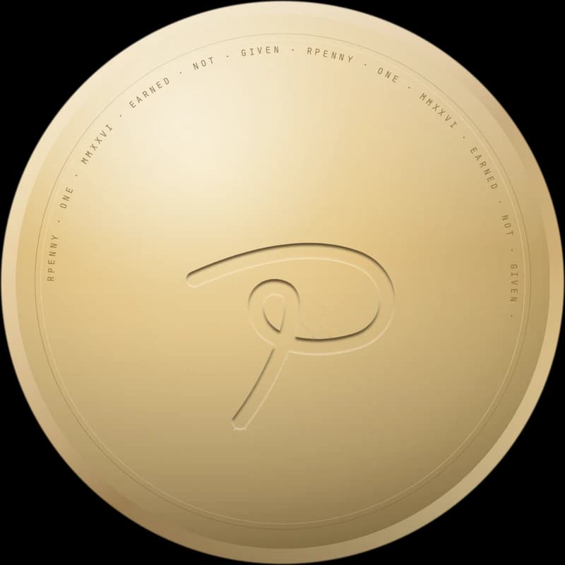 The Rpenny coin: champagne gold with an engraved looping P mark and the words Rpenny, one, earned, not given around the edge.
